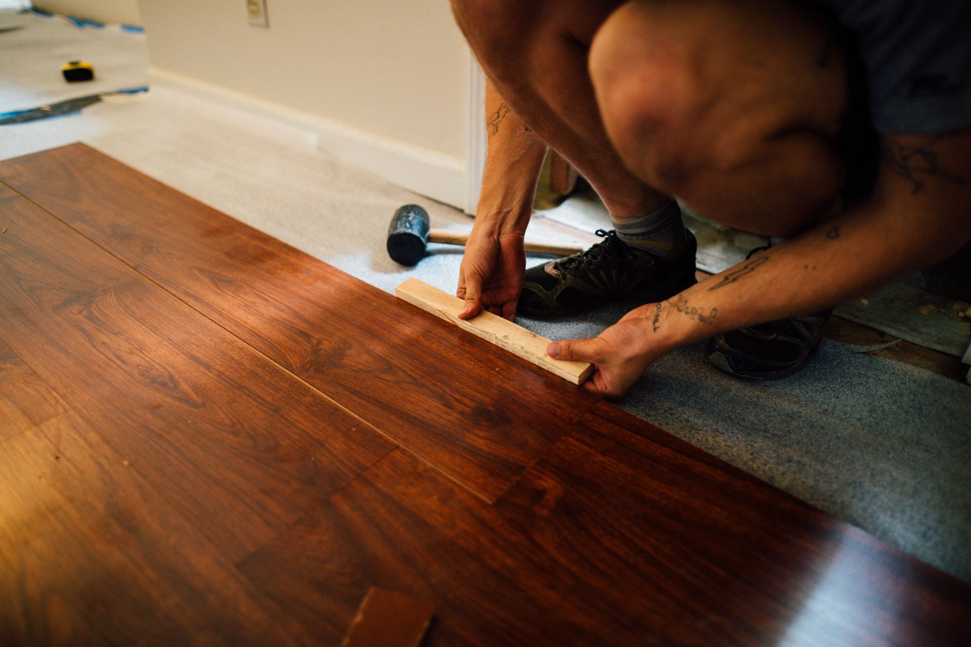 Installing dark-stained plank flooring over underlayment