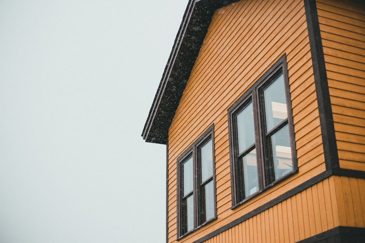 Fresh horizontal siding with dark corner trim and black-framed windows